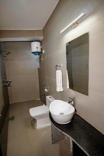 a bathroom with a sink and a toilet at The Core in Kohīma