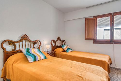 Ένα ή περισσότερα κρεβάτια σε δωμάτιο στο Apartamento de playa en Cullera