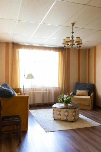 a living room with a couch and a coffee table at Talsu Vecpilsētas apartmenti in Talsi
