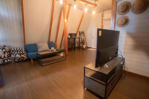 a living room with a flat screen tv on a table at นานาเพชรบูรณ์ รีสอร์ท&คาเฟ่ 