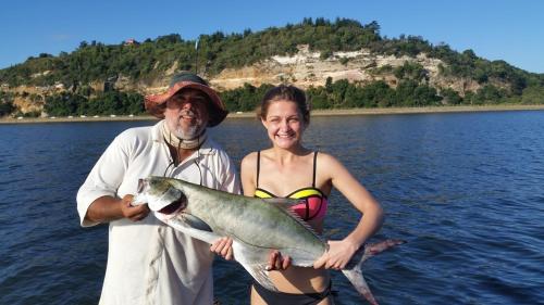 a man and a woman holding a large fish at 29 Cutty Sark in Plettenberg Bay