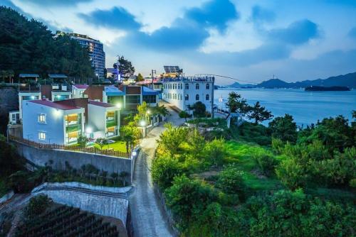 a view of a city with a river and buildings at Tongyeong Travel Guest Pension in Kwangsanch'on