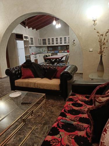 a living room with a couch and a table at The quiet house in Sfax