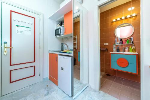 a kitchen with a red door and orange tiles at LoopINN Granada in Granada