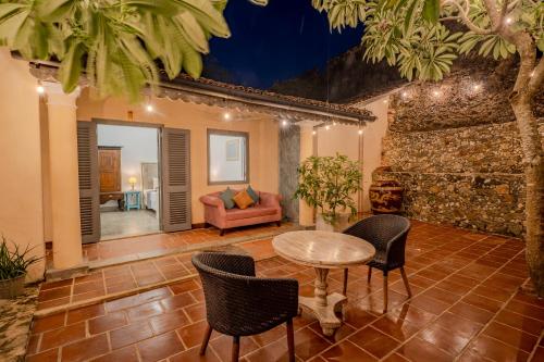 a living room with a table and chairs and a couch at The Dutch Bungalow in Galle