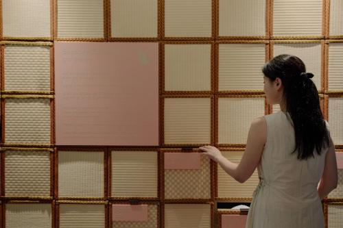 a woman standing in front of a wall of windows at Sowon Ryokan and Hotel by Aank Sangbong in Seoul