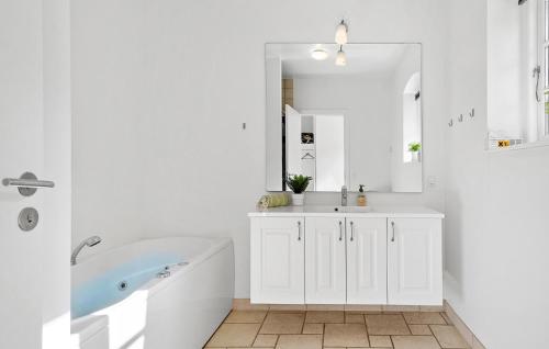 a white bathroom with a tub and a sink at Beautiful Apartment In Nimtofte With Wifi in Nimtofte