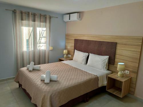 a bedroom with a bed with two candles on it at Ktima Bilionis in Kakóvatos