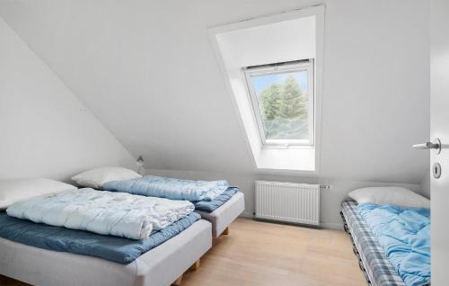 two beds in a room with a window at Gorgeous Apartment In Nimtofte With Wifi in Nimtofte