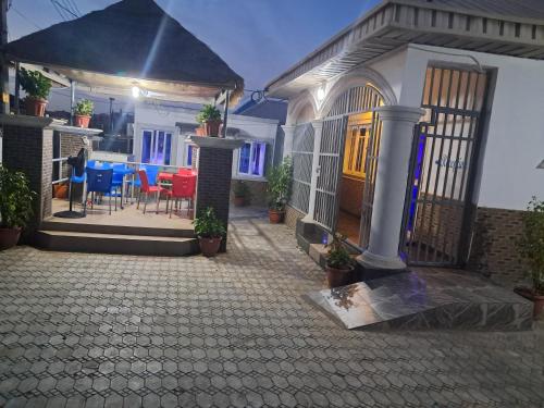 a house with a patio and a table and chairs at GOCAP Guest house in Rubuchi