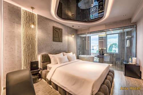 a hotel room with a large bed and a window at Oria Hotel Gò Vấp in Ho Chi Minh City