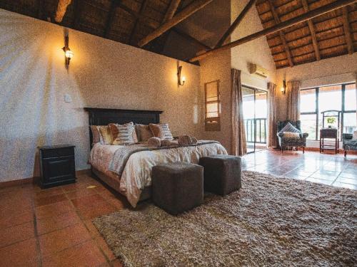 a bedroom with a large bed in a room at Weavers Nest Guesthouse in Modimolle