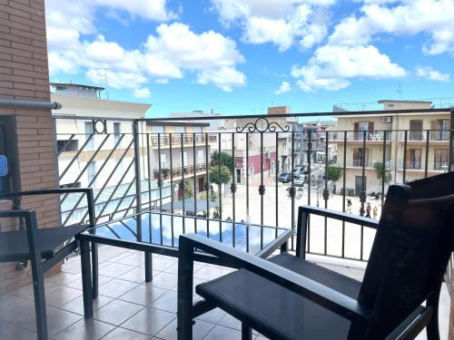 a balcony with two benches and a view of a city at B&B CORSO ROMA Room Suite & Spa in Apricena