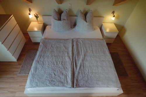 a bedroom with two beds with pillows on them at Haus am See Ferienhaus 4 in Wackersdorf