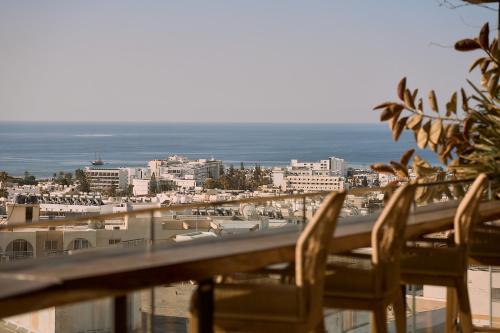 a balcony with chairs and a view of the ocean at Hotel Napa Suites (Adults Only) in Ayia Napa