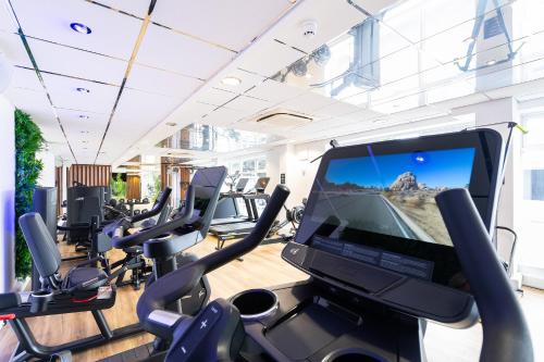a gym with cardio machines and a large screen television at The Barnstaple Hotel in Barnstaple