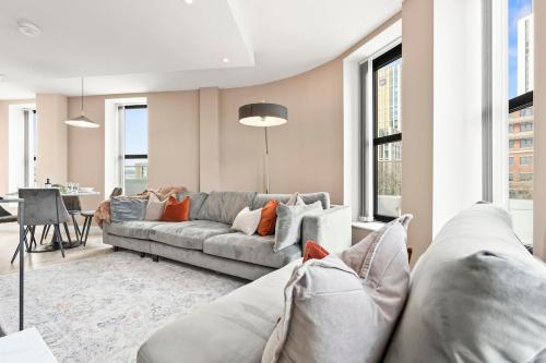 a living room with a couch and a table at Central Leeds Penthouse 2Bed 2Bath Arena in Central Station