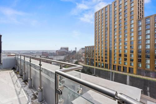 a view of a city from a balcony with buildings at Central Leeds Penthouse 2Bed 2Bath Arena in Central Station