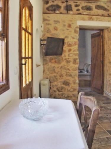 a white table with a glass bowl on top of it at Castle's House in Véssa