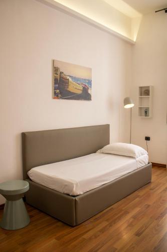 a bedroom with a bed in a white room at BADIA NUOVA Apart Hotel in Trapani