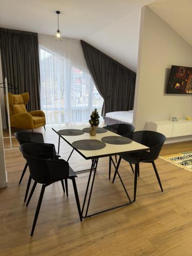 a living room with a table and chairs at Yaremche Apartments in Yaremche