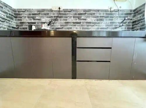 a kitchen with a counter top and a sink at The Driftwood Dan Studio Flat Colva, anirah in Colva
