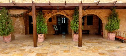 a courtyard with potted plants in a stone building at Hayat Zaman Hotel And Resort Petra in Wadi Musa