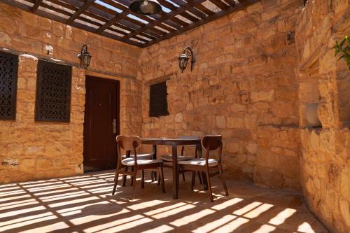 a table and two chairs on a patio at Hayat Zaman Hotel And Resort Petra in Wadi Musa