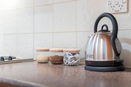 a tea kettle on a counter in a kitchen at 404 Big Beautiful One Bed & Balcony in Perth