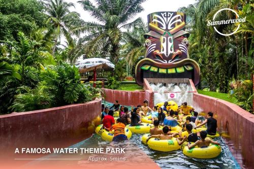 a group of people riding on tubes in a water theme park at Afamosa Sunset Villa 22pax Snooker BBQ KTV New in Kampong Ulu Pegoh