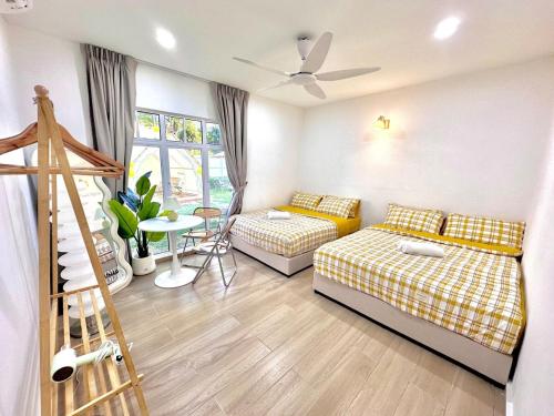 a living room with two beds and a table at Afamosa Sunset Villa 22pax Snooker BBQ KTV New in Kampong Ulu Pegoh