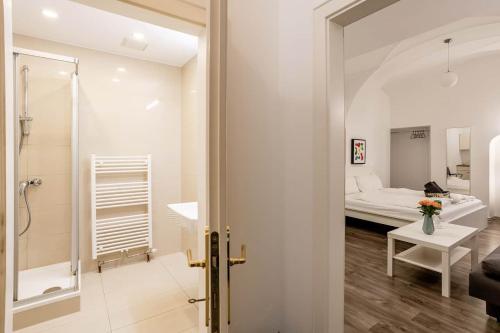a bathroom with a shower and a bedroom with a bed at Beautiful Apartment 3 City Center in Vienna