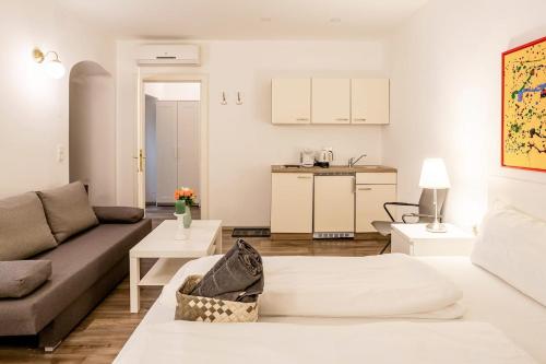 a living room with a couch and a kitchen at Beautiful Apartment 3 City Center in Vienna