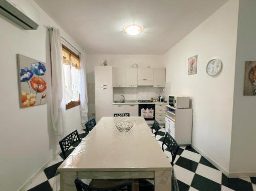 a kitchen with a table and a counter top at Domu Nova in Pula
