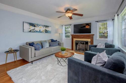 a living room with two couches and a fireplace at Style Meets Comfort in Beautiful Design in Vancouver