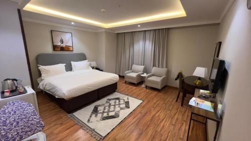 una camera d'albergo con un letto e una televisione di فندق راحة السلام a Buraydah