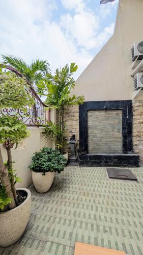 a courtyard with potted plants and a building at Surabaya Homey Dharmahusada Syariah in Surabaya
