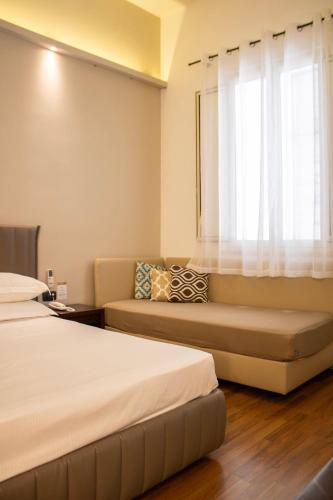 a hotel room with two beds and a window at BADIA NUOVA Apart Hotel in Trapani
