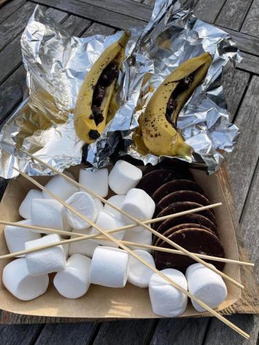 a box of chocolate donuts and bananas and marshmallows at Big Sky Tipi Holidays in Wartling