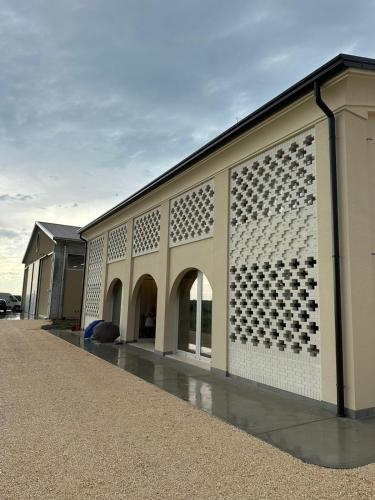 a building with a pattern on the side of it at Cal Vecia Agriturismo in Calvecchia