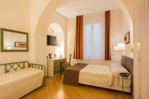 Ένα ή περισσότερα κρεβάτια σε δωμάτιο στο Piazza Paradiso Accommodation