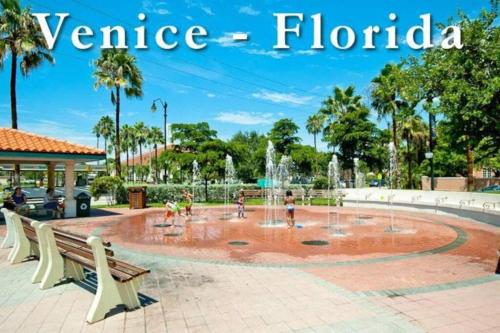 a fountain in a park with people playing in it at Great Shape After Milton-pool Home Wows! Po in Venice