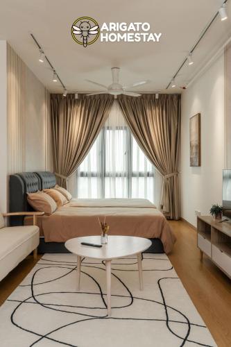 a bedroom with a bed and a table in a room at Friendly Stay SplashMania Fun & Near KLIA Premium Netflix in Bandar Gamuda Cove