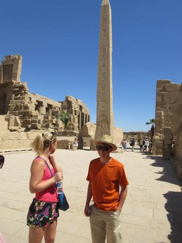 a man and a woman standing in front of the obelisk at Bastet Retreat Hotel in Luxor