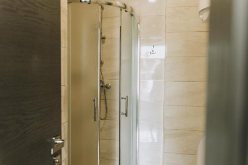 a shower with a glass door in a bathroom at SeaLine Apart-Hotel in Odesa