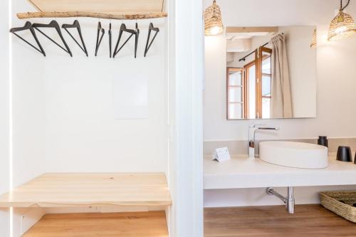 a bathroom with a sink and a mirror at Hotel Ses Sis Roses in Ciutadella