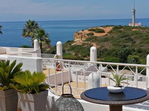 a balcony with a table and a view of the ocean at OCEAN TERRACES VILA GAIVOTA J in Ferragudo