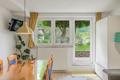 a dining room with a table and a window at Hisa Taljat in Most na Soči