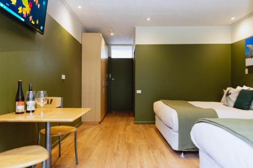 a hotel room with a bed and a table at The Bright Motor Inn in Bright