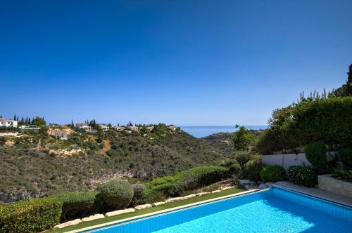 a swimming pool with a view of the ocean at 4 bedroom Villa Helidoni with private infinity pool, Aphrodite Hills Resort in Kouklia